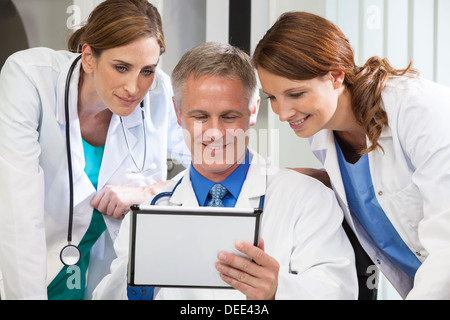 Male & female medical doctors medical team using tablet computer in a hospital office Stock Photo
