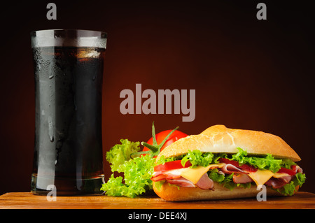 still life with sandwich, vegetables and cola drink Stock Photo