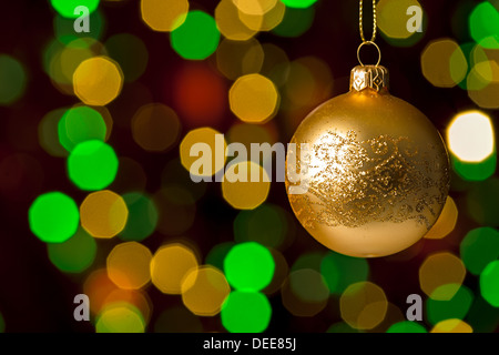 Christmas ball hanging defocused sparkling lights on the background Stock Photo