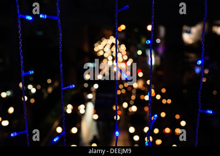 Christmas lights with traffic out of focus in the background. Siam Square. Bangkok. Thailand. Stock Photo