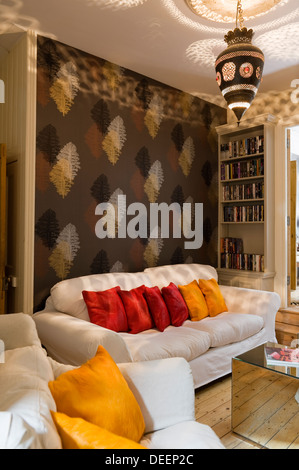 Living area with mirrored Armada cubes, a Moroccan lantern and silk cushions of warm spice tones Stock Photo