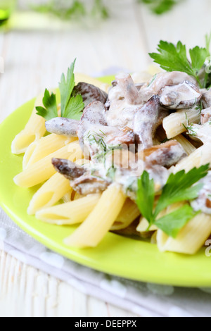 pasta with roasted mushrooms in sour cream, food close up Stock Photo