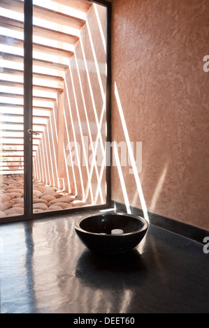 Candle in bow at glass door of Moroccan new-build with interior design Romain Michel-Meniere Stock Photo