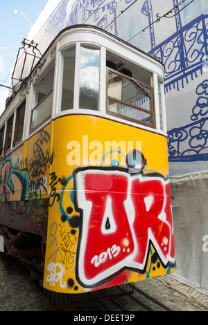 A graffiti covered funicular/tram in Lisbon, Portugal Stock Photo