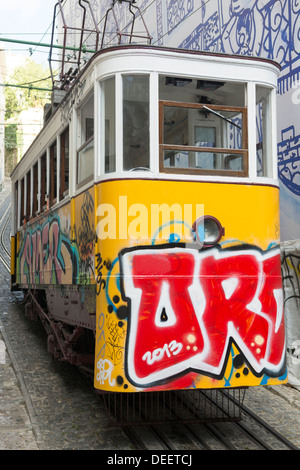 A graffiti covered funicular/tram in Lisbon, Portugal Stock Photo