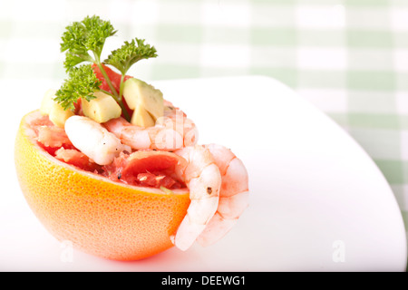 shrimps and grapefruit salads on white plate Stock Photo