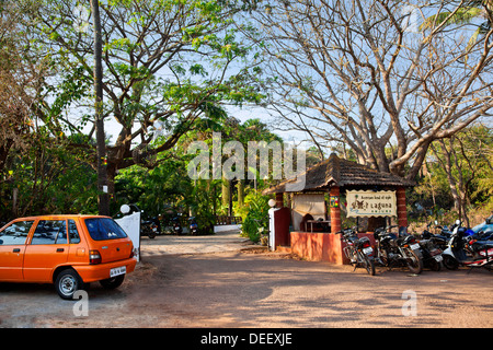 Vehicles parked near the entrance of a hotel, Laguna Anjuna, Sorantto Vado, Anjuna, Bardez, North Goa, Goa, India Stock Photo