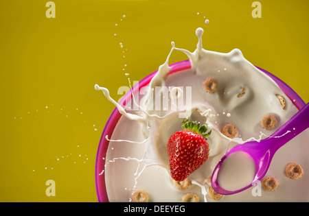 Strawberry Splashing Milk In Bowl Of Cereal Stock Photo