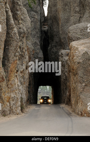 A car enters one of the tunnels on the Needles Highway, Custer State Park, South Dakota. Stock Photo