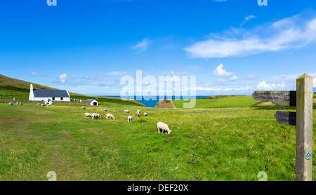The Ceredigion Coast Path passing in front of the Church of the Holy Cross, Mwnt, Ceredigion, Wales, UK Stock Photo