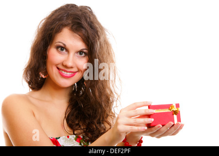 Girl opening small red gift box with gold bow isolated on white background Stock Photo