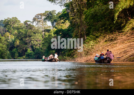 Africa, Cameroon, Kribi. Tourists in traditional pirogue boat going down Lobe River. Stock Photo