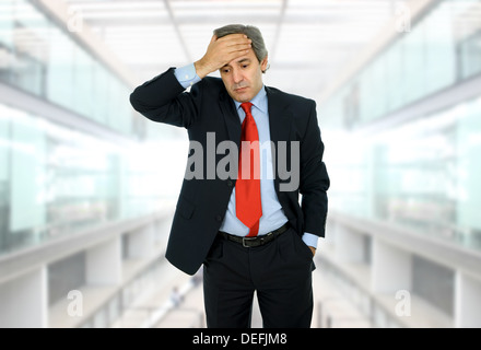 Businessman in a suit gestures with a headache Stock Photo