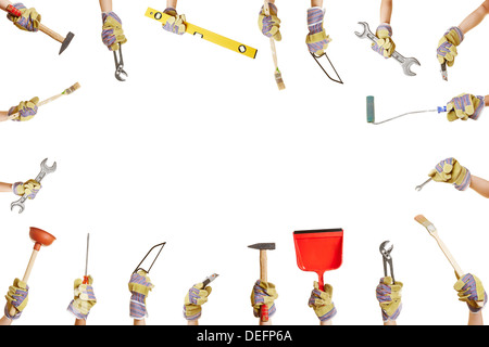 Frame with many hands holding different work tools for construction and repairing Stock Photo