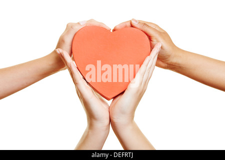 Many hands holding red a big heart together Stock Photo
