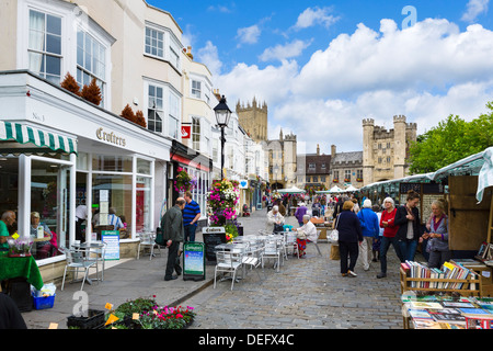 Market stalls in the Market Place with the Cathedral and Bishop's Palace behind, Wells, Somerset, England, UK Stock Photo
