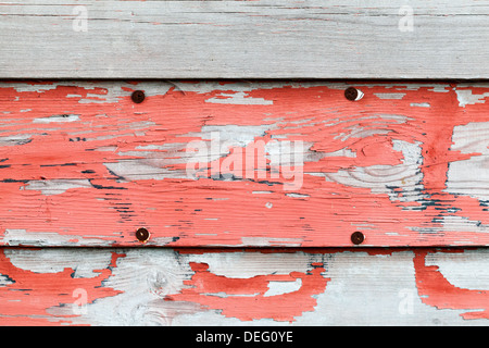 Old obsolete advertisement wooden wall with red paint and rusted pushpins Stock Photo