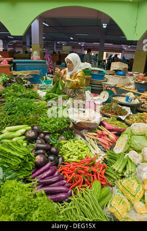 Women selling fruit and vegetables in the town's central market, Kota Bharu, Kelantan State, Malaysia, Southeast Asia, Asia Stock Photo