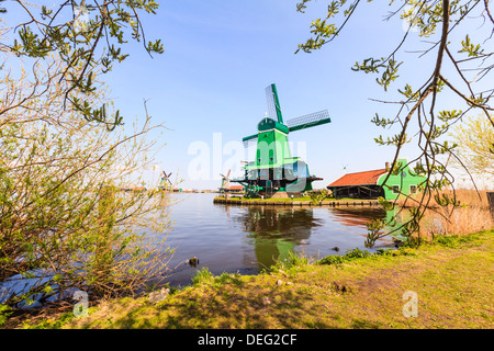 Historic windmills and houses in Zaanse Schans on the banks of the river Zaan, near Amsterdam, Zaandam, Netherlands Stock Photo