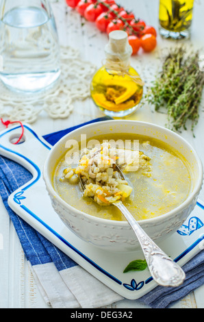 Pearl barley soup on a blue towel Stock Photo