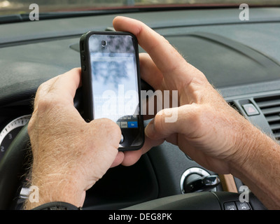Male Hands Text Messaging While Driving Stock Photo