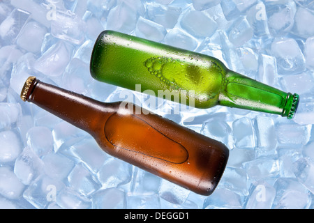 Two bottles of beer cooling on ice. Stock Photo
