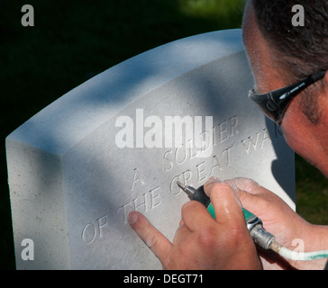 Headstone re-engraving in Tyne Cot British war cemetery in preparation for 2014 centenary of outbreak of WW1 Stock Photo