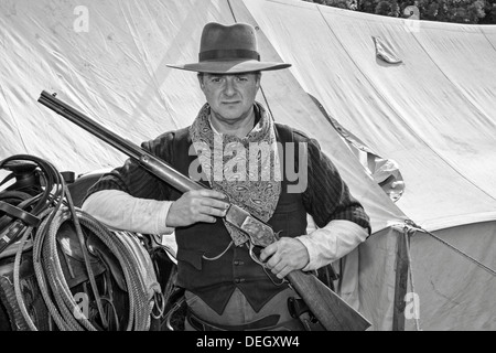 Armed Philip Twaites Cowboy, holding a breech-loading single-shot lever-actuated rifle gun used by the British Army at Ingleton's Wild West Weekend UK Stock Photo