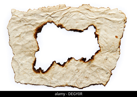 Hole burnt in paper on plain background. Copy space Stock Photo