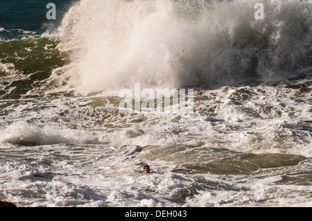 Teenage boy in trouble in big surf at Snapper Rocks, Gold Coast, Queensland, Australia Stock Photo