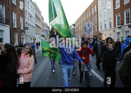 Dublin, Ireland. 18th September 2013. Activists from the Irish Republican Voice group march through the protest. Protesters hold a People's Assembly outside the Dail (Irish Parliament), to discuss austerity in smaller groups. The assembly was part of a day of protests to coincide with the return of the TDs (Members of Parliament) from their summer break. Credit:  Michael Debets/Alamy Live News Stock Photo