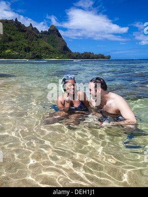 Snorkelers at Tunnels Beach on Kauai, with Mt. Makana, called Bali Hai, in distance Stock Photo