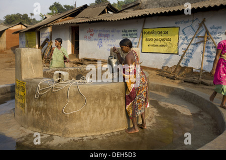 Woman drawing water from well, Orissa, India Stock Photo