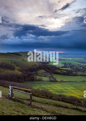 Dark moody skies form over bright fresh Spring countryside landscape Stock Photo