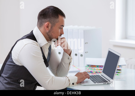 Young businessman using laptop desk Stock Photo
