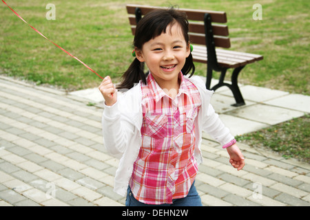 A girl playing outside Stock Photo