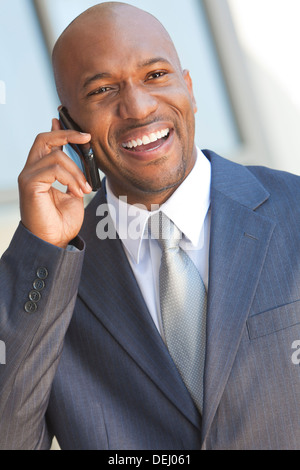 Successful African American businessman or man in a suit in a modern city talking on his cell phone Stock Photo