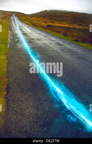 Fiber optic cable running above ground the British Countryside Stock Photo