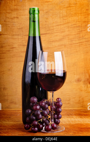 red wine and grapes on a wooden background Stock Photo
