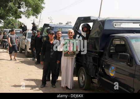 Cairo, Cairo, Egypt. 19th Sep, 2013. Egyptian security forces stand guard at the entrance to Kerdasa, a town 14 km (9 miles) from Cairo September 19, 2013, as Egyptian security forces clashed with gunmen on the outskirts of the capital. Egyptian security forces clashed with gunmen on the outskirts of Cairo on Thursday as the army-backed government moved to reassert control over Islamist-dominated Kerdasa where militants staged a bloody attack on a police station last month Credit:  Ahmed Asad/APA Images/ZUMAPRESS.com/Alamy Live News Stock Photo