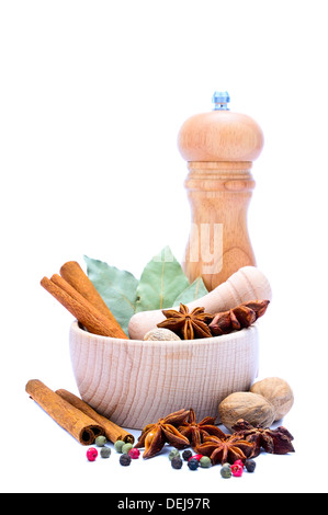 different spices with mortar, pestle and pepper mill isolated on a white background Stock Photo