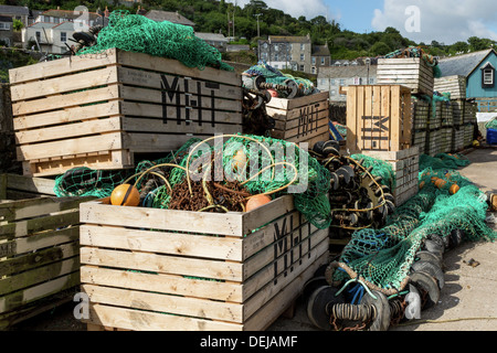 This vertical image has fishing stuff and equipment in a yard