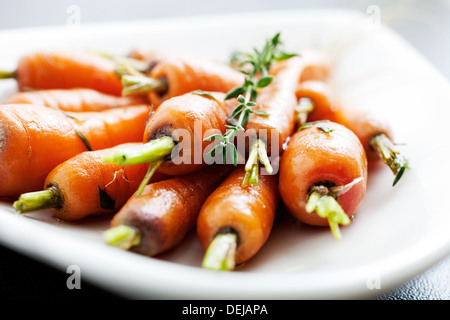 Close up of carrots with fresh thyme  Stock Photo
