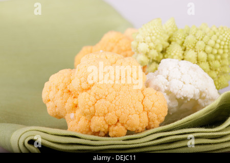 yellow, green and white cauliflower on the green cloth Stock Photo