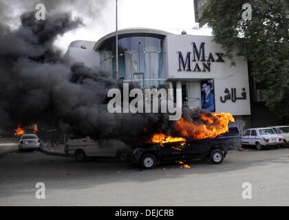 Cairo, Cairo, Egypt. 19th Sep, 2013. A burning Egyptian police car is seen in front of al-Zamalek football club's headquarters in Cairo on Sept. 19, 2013. Members of a hardcore group of fans of the Zamalek football club, the Ultra White Knights (UWK), stormed the club's headquarters in Cairo on Thursday following a protest demanding changes to the club's leadership Credit:  Ahmed Asad/APA Images/ZUMAPRESS.com/Alamy Live News Stock Photo