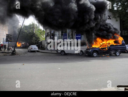 Cairo, Cairo, Egypt. 19th Sep, 2013. A burning Egyptian police car is seen in front of al-Zamalek football club's headquarters in Cairo on Sept. 19, 2013. Members of a hardcore group of fans of the Zamalek football club, the Ultra White Knights (UWK), stormed the club's headquarters in Cairo on Thursday following a protest demanding changes to the club's leadership Credit:  Ahmed Asad/APA Images/ZUMAPRESS.com/Alamy Live News Stock Photo