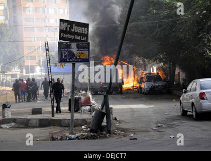 Cairo, Cairo, Egypt. 19th Sep, 2013. A burning Egyptian police car is seen in front of al-Zamalek football club's headquarters in Cairo on Sept. 19, 2013. Members of a hardcore group of fans of the Zamalek football club, the Ultra White Knights (UWK), stormed the club's headquarters in Cairo on Thursday following a protest demanding changes to the club's leadership Credit:  Ahmed Asad/APA Images/ZUMAPRESS.com/Alamy Live News Stock Photo