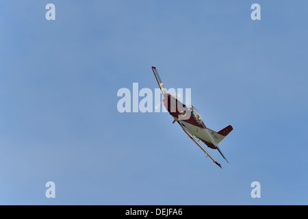 Pilatus PC-7 banking in blue skies with clear view of two pilots Stock Photo