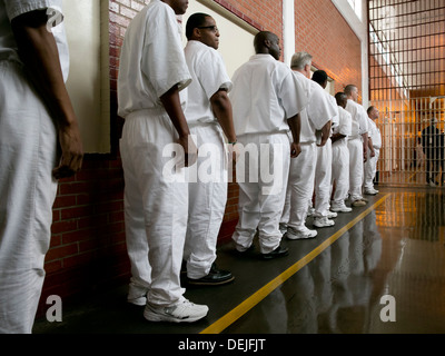 Male inmates at the Darrington Unit near Houston, Texas line up inside prison to attend event Stock Photo