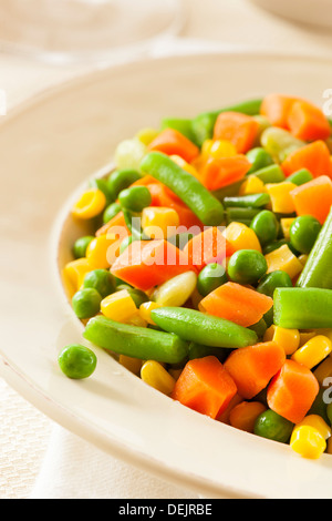 Steamed Organic Vegetable Medly with Peas, Corn, Beans, and Carrots Stock Photo